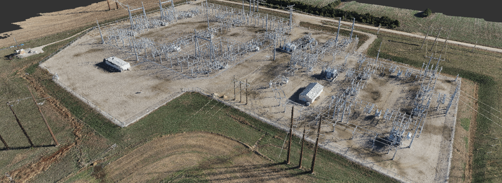 A 3D point cloud in isometric aerial view of an electrical substation surrounded by agricultural land, showing intricate details of power transmission infrastructure and surrounding landscape.