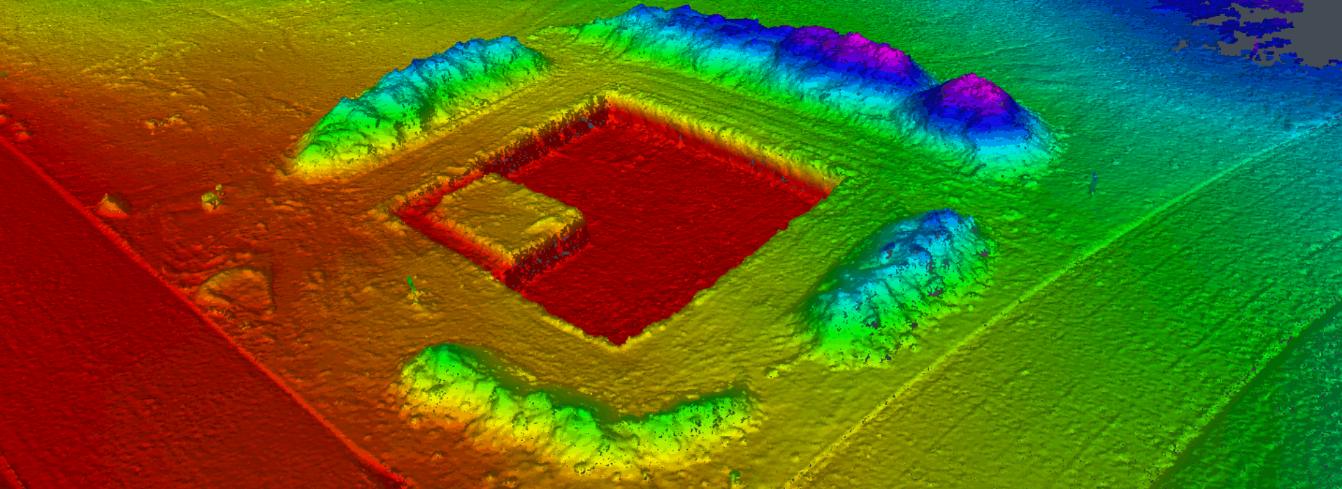 A high-resolution digital elevation model (DEM) with a colorized topographic representation of a terrain, highlighting elevation changes with a gradient from red (low areas) to blue (high areas).