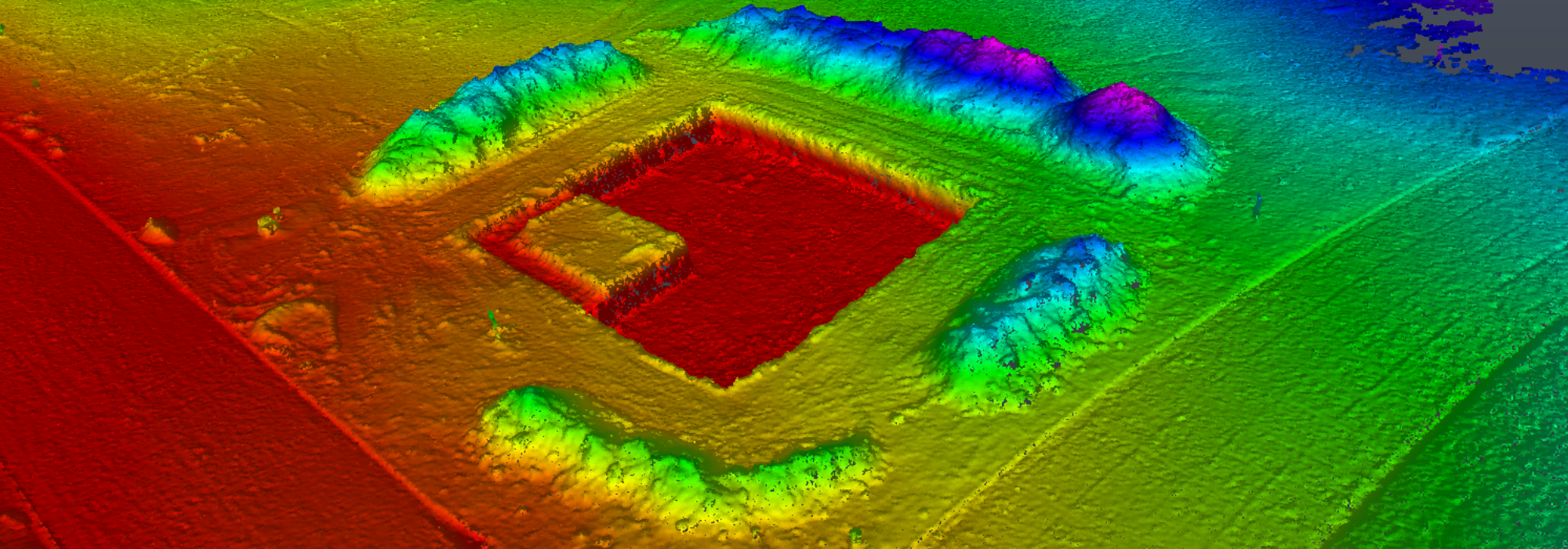 A high-resolution digital elevation model (DEM) with a colorized topographic representation of a terrain, highlighting elevation changes with a gradient from red (low areas) to blue (high areas).